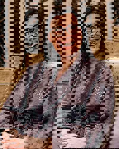 Smiling guest in spa robe at The Well at Cliff