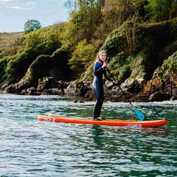 Guest stand-up paddleboarding off the coast of Ardmore