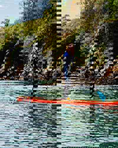 Guest stand-up paddleboarding off the coast of Ardmore