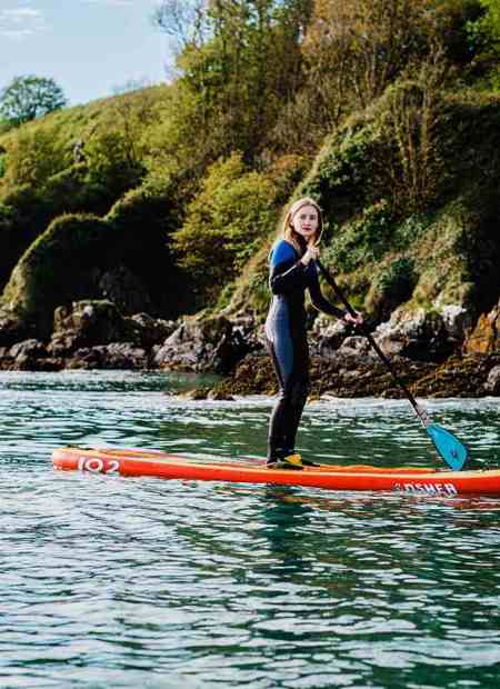 Guest stand-up paddleboarding off the coast of Ardmore