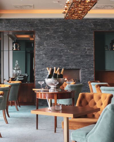 Lounge seating with fireplace at Cliff House Hotel Ardmore