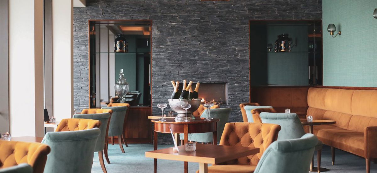Lounge seating with fireplace at Cliff House Hotel Ardmore
