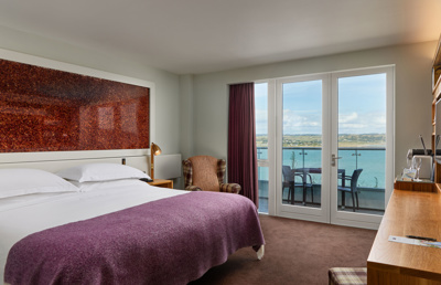 Glass balconies offer dramatic views of the atlantic blue at Cliff House Hotel