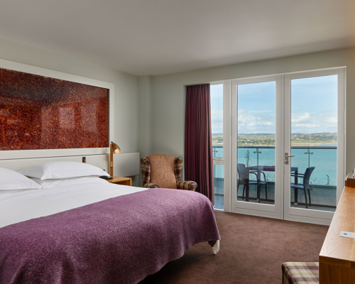 Glass balconies offer dramatic views of the atlantic blue at Cliff House Hotel