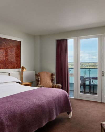 Glass balconies offer dramatic views of the atlantic blue at Cliff House Hotel