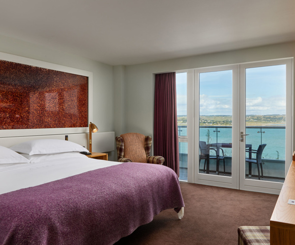 Glass balconies offer dramatic views of the atlantic blue at Cliff House Hotel