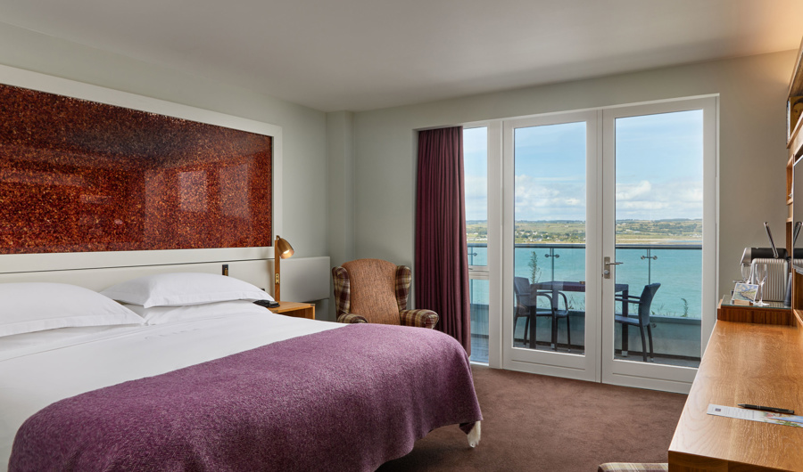 Glass balconies offer dramatic views of the atlantic blue at Cliff House Hotel
