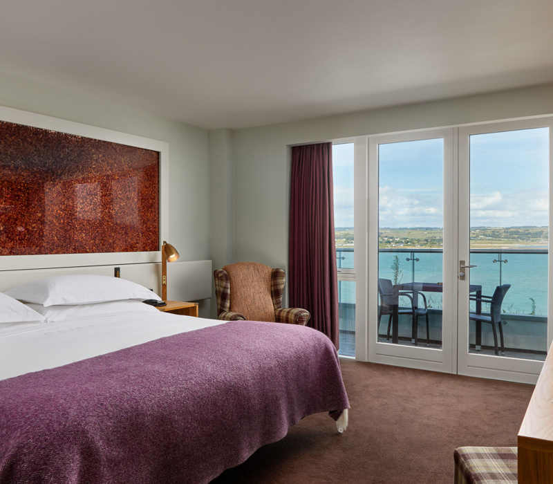 Glass balconies offer dramatic views of the atlantic blue at Cliff House Hotel