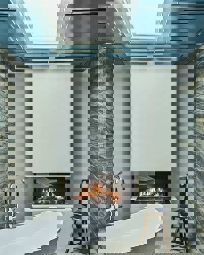 Freestanding bath and fireplace at Cliff Beach House bathroom