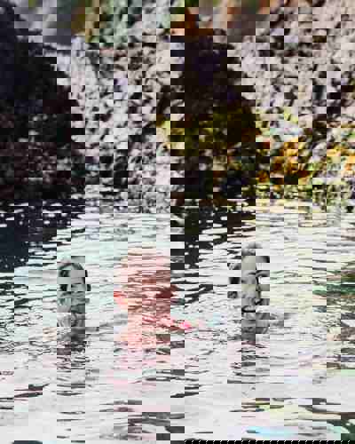 Guest swimming in the sea near Cliff House Hotel