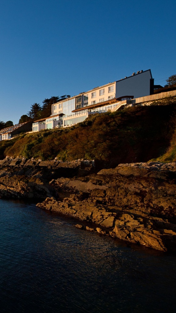 Exterior view of Cliff House Hotel from the water on Ardmore Bay looking up to the hotel built into the cliff.